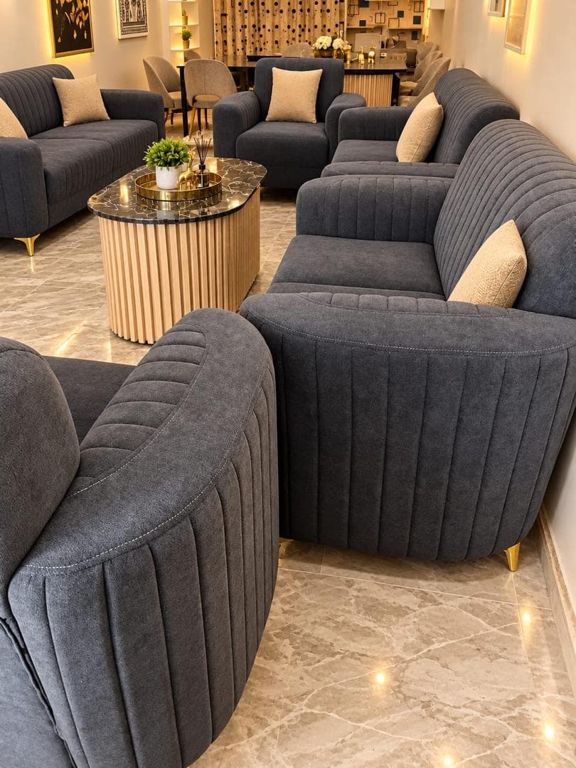 Close view of fluted, curved armrests on charcoal sofas