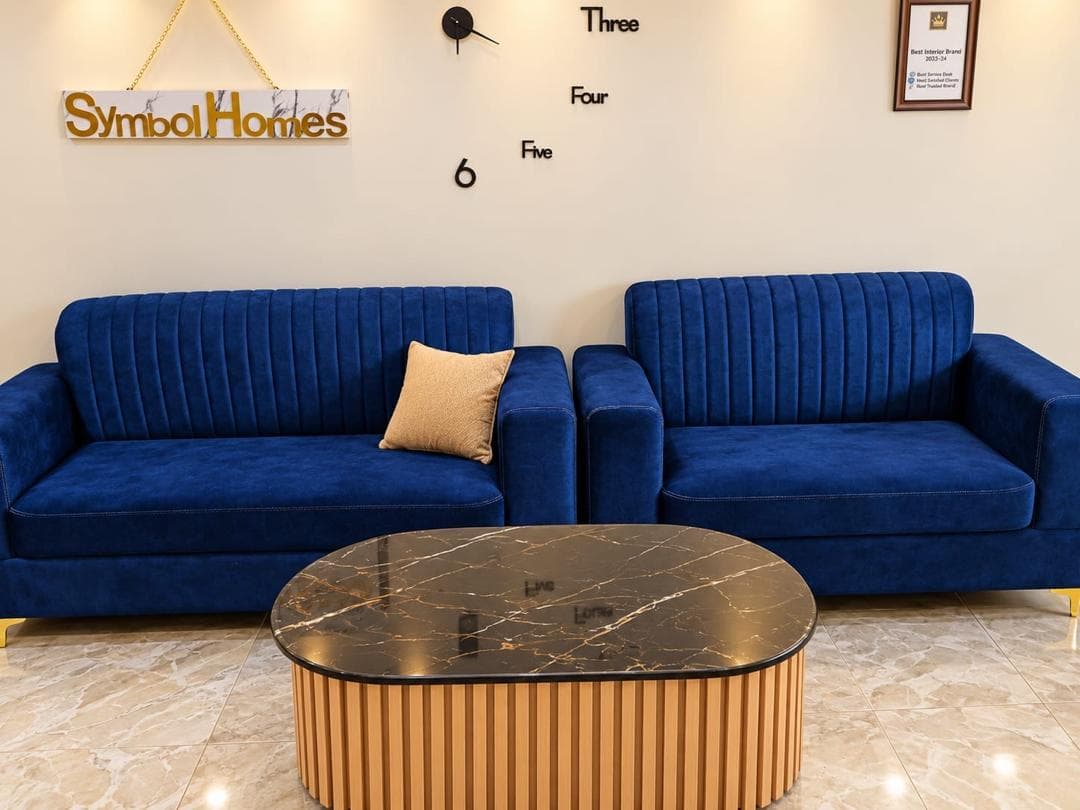 Two blue velvet three-seater sofas side by side