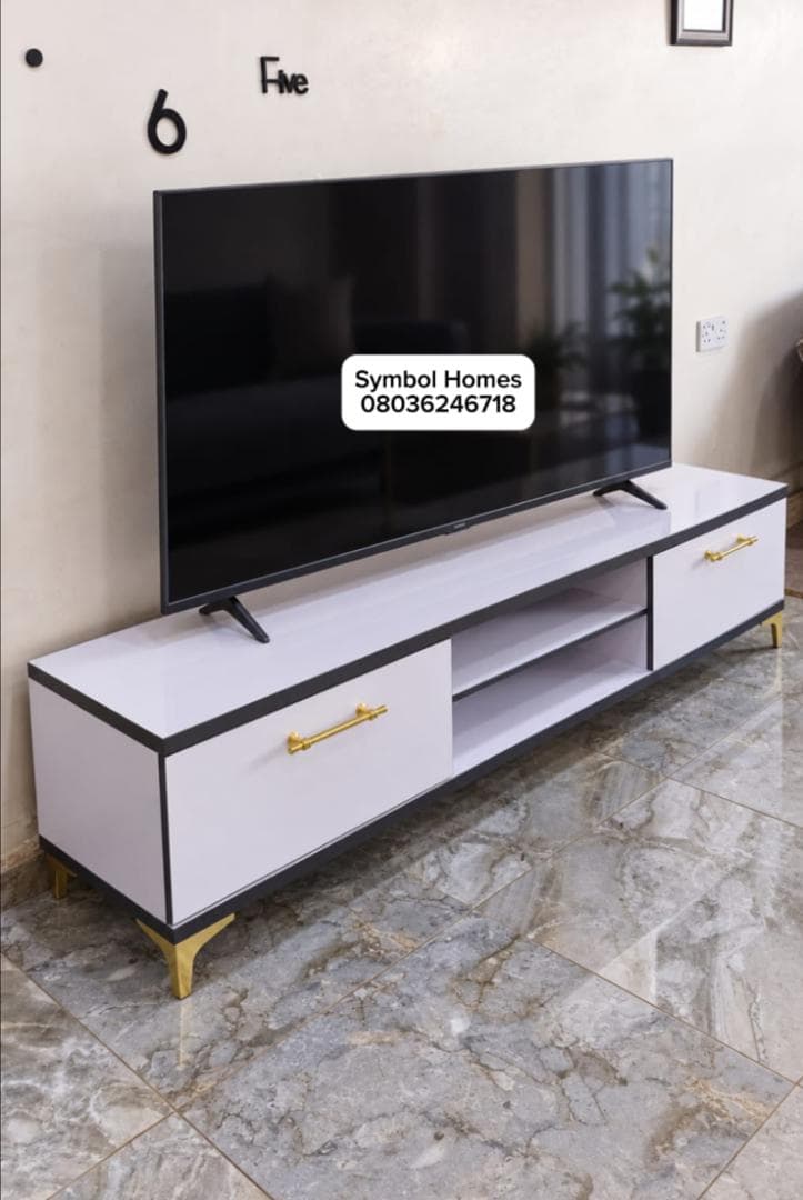 White TV console with gold handles and legs